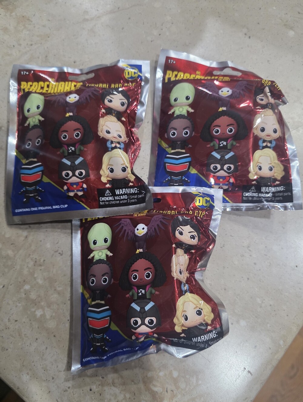Three DC Peacemaker Blind Bag Collectible Figures - Red & Blue Packaging